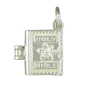 Sterling silver Bible-shaped charm with polished finish and jump ring attachment, designed for charm bracelets or necklaces.